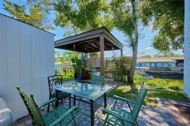 view of patio featuring fence and outdoor dining area