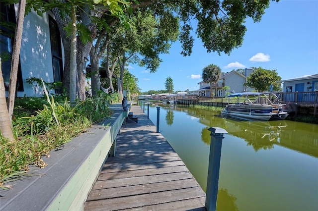 dock area with a residential view and a water view