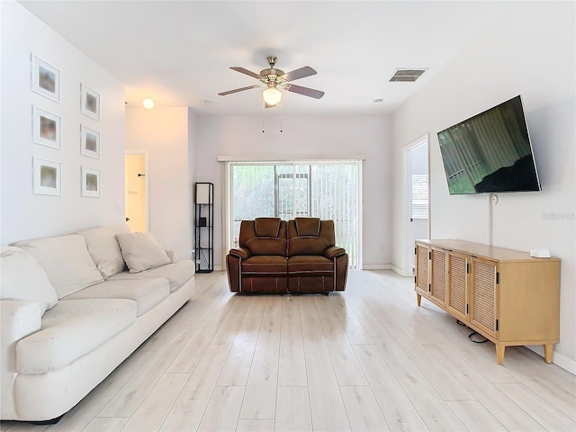 living room with light hardwood / wood-style flooring and ceiling fan