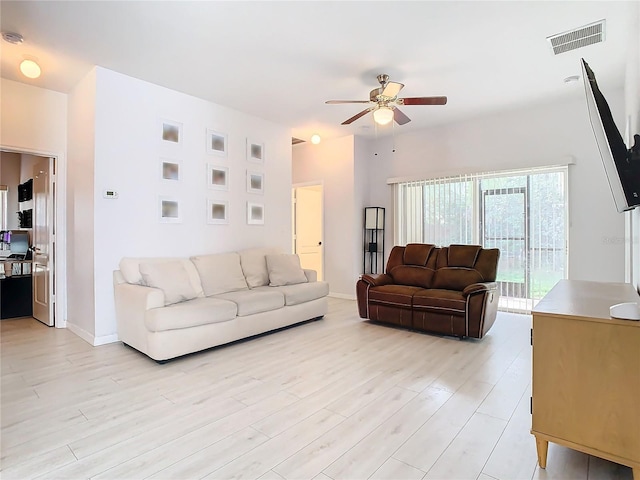 living room with light hardwood / wood-style flooring and ceiling fan