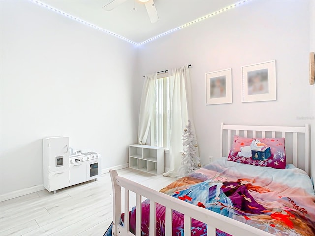 bedroom with ceiling fan and light hardwood / wood-style floors