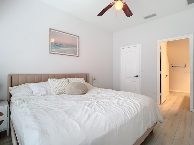 bedroom with light hardwood / wood-style flooring and ceiling fan