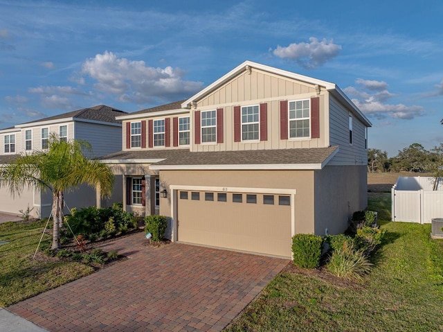 view of front of property featuring a garage and a front yard