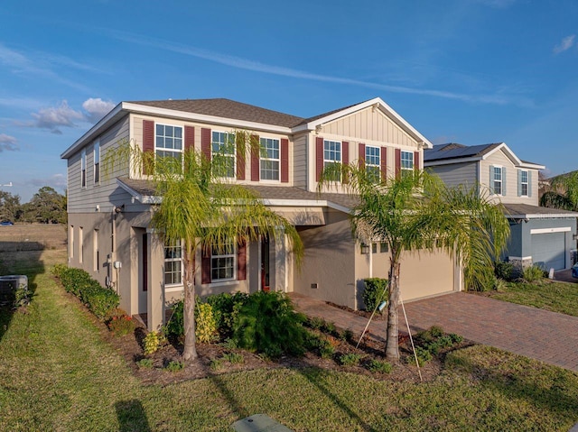 view of front of home with a garage and a front lawn