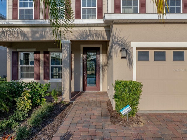 doorway to property with a garage