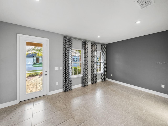 tiled spare room with a wealth of natural light