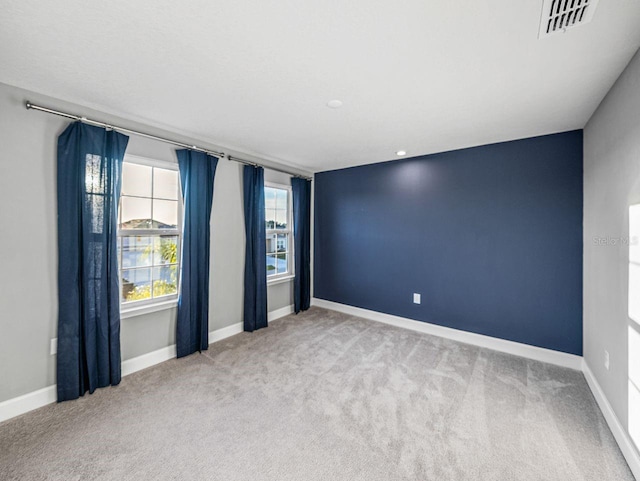 unfurnished room with light colored carpet