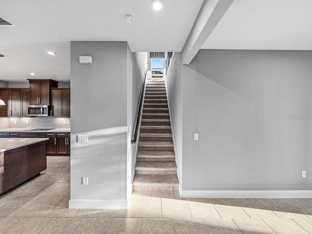 stairway with tile patterned flooring