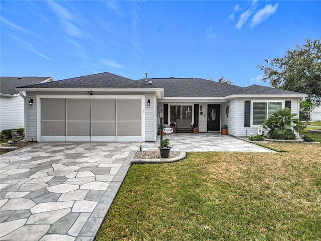 ranch-style home featuring a garage and a front lawn