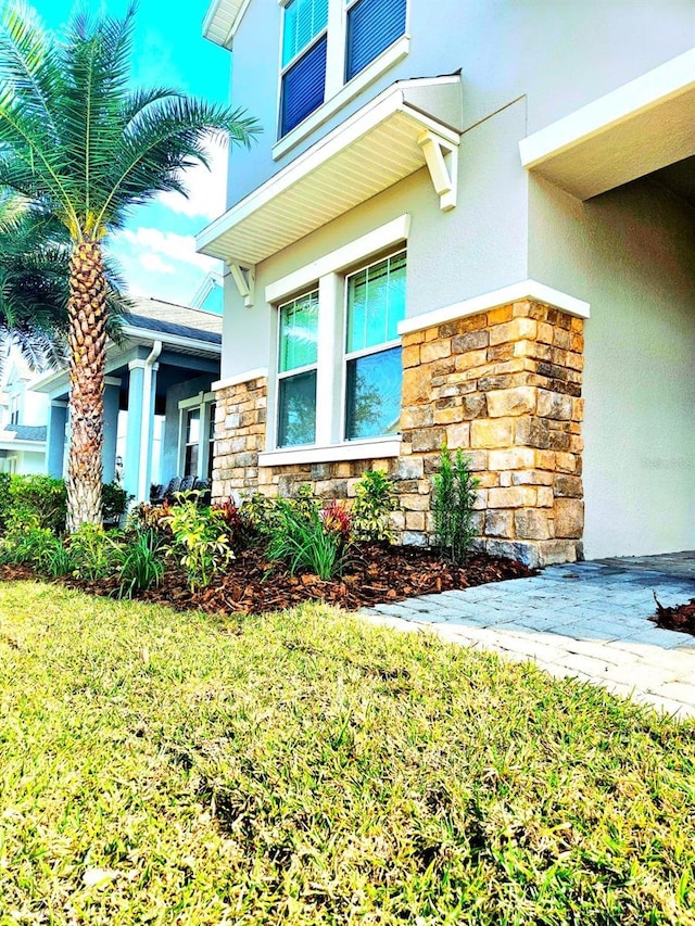 view of side of home featuring a lawn