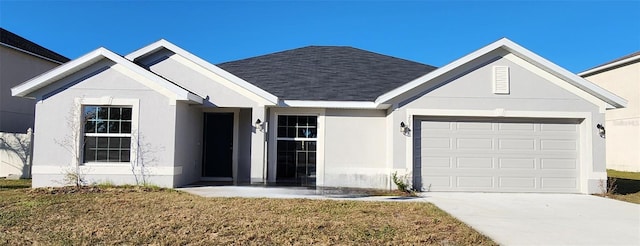 view of front of house featuring a garage and a front lawn