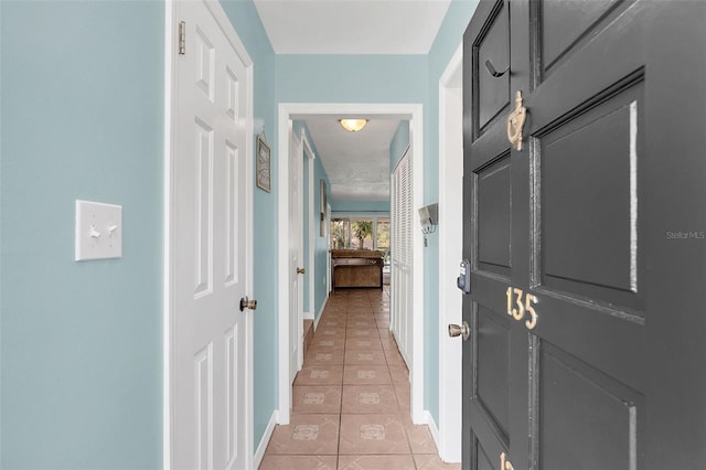 hallway with light tile patterned floors