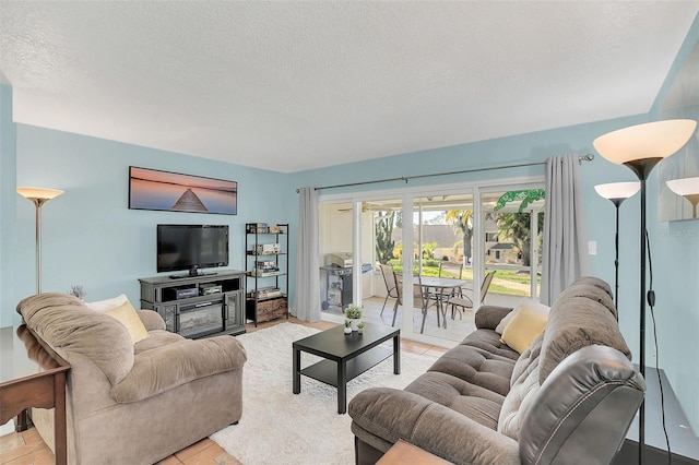 tiled living room featuring a textured ceiling