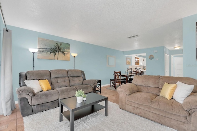 tiled living room with a textured ceiling