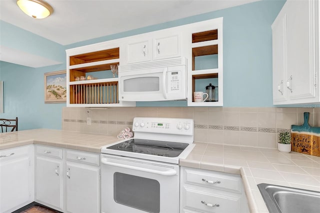 kitchen featuring white cabinetry, tile counters, white appliances, and decorative backsplash