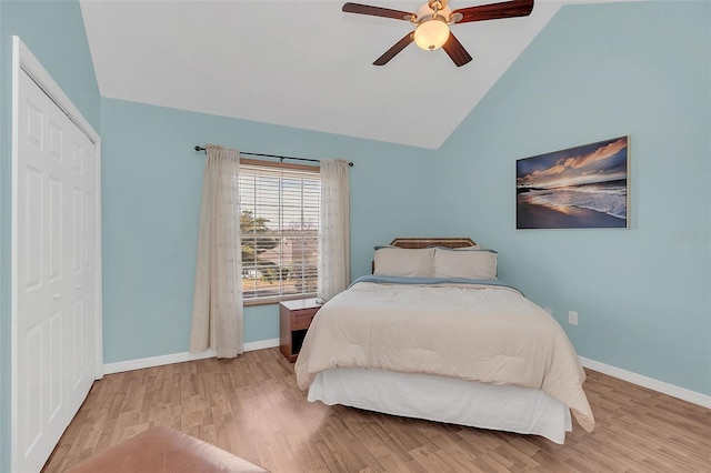 bedroom with vaulted ceiling, ceiling fan, light hardwood / wood-style floors, and a closet