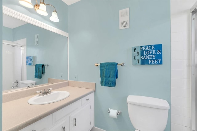 bathroom with vanity, walk in shower, and toilet