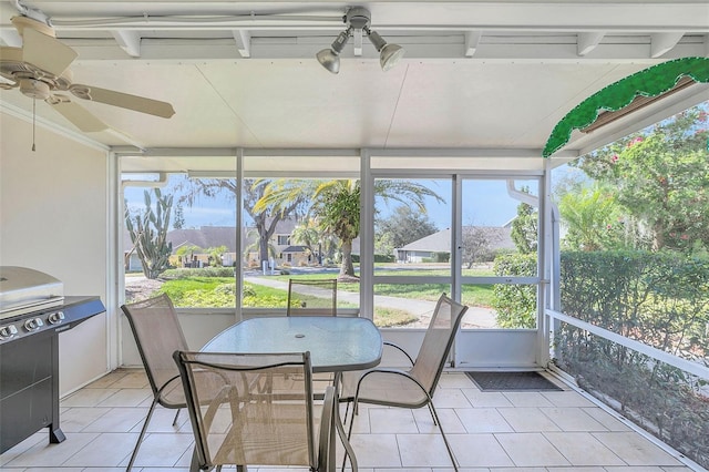 sunroom / solarium with ceiling fan and a healthy amount of sunlight