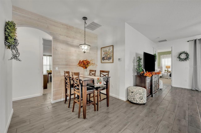 dining area featuring wood walls