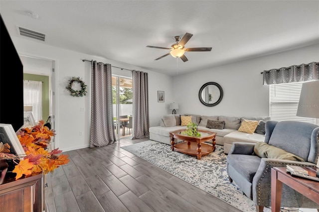 living room featuring wood-type flooring and ceiling fan