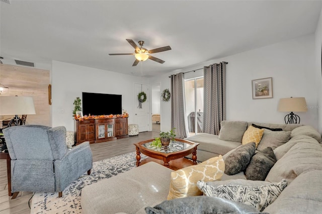 living room featuring ceiling fan and light wood-type flooring