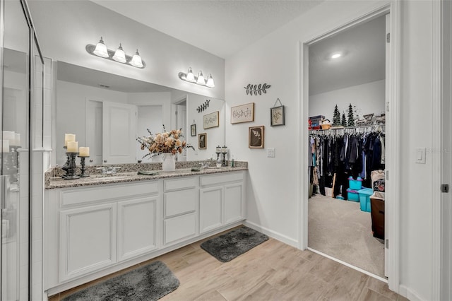 bathroom featuring vanity and hardwood / wood-style flooring