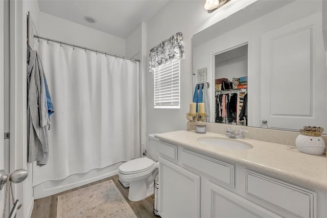 full bathroom with vanity, hardwood / wood-style flooring, toilet, and shower / tub combo with curtain