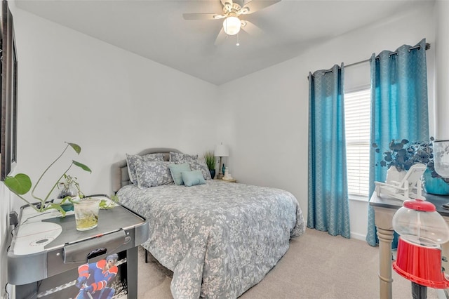 bedroom featuring light colored carpet and ceiling fan