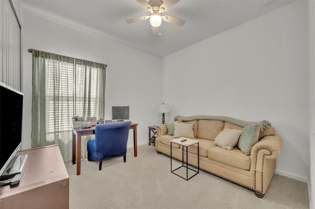 carpeted home office featuring ceiling fan