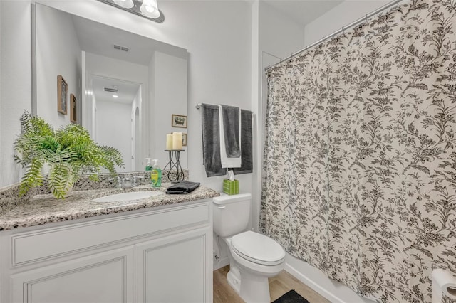 bathroom featuring vanity, toilet, and a shower with shower curtain