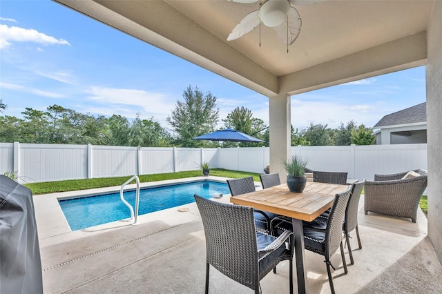 view of pool with grilling area, a patio, and ceiling fan