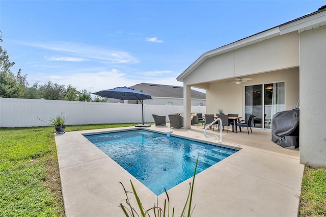 view of pool featuring grilling area, a yard, a patio area, and ceiling fan