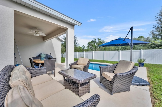 view of patio / terrace featuring ceiling fan, an outdoor hangout area, and a fenced in pool