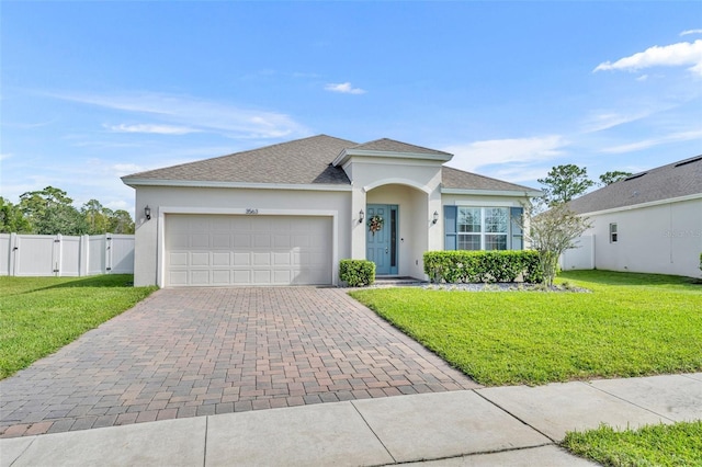 view of front of house with a garage and a front yard