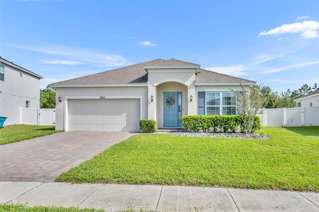 view of front of property with a garage and a front lawn