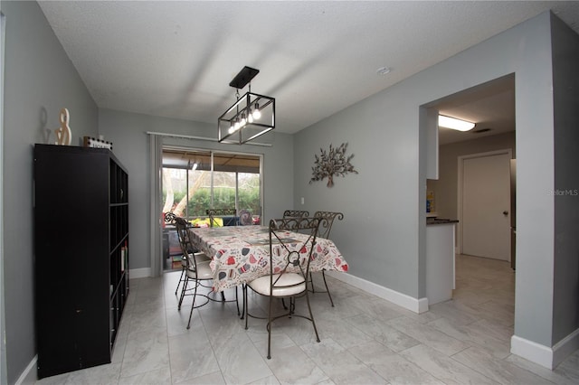 dining area featuring a textured ceiling