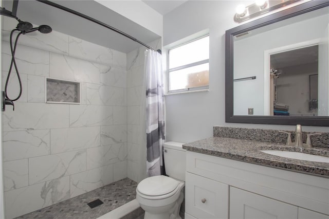 bathroom with vanity, curtained shower, and toilet