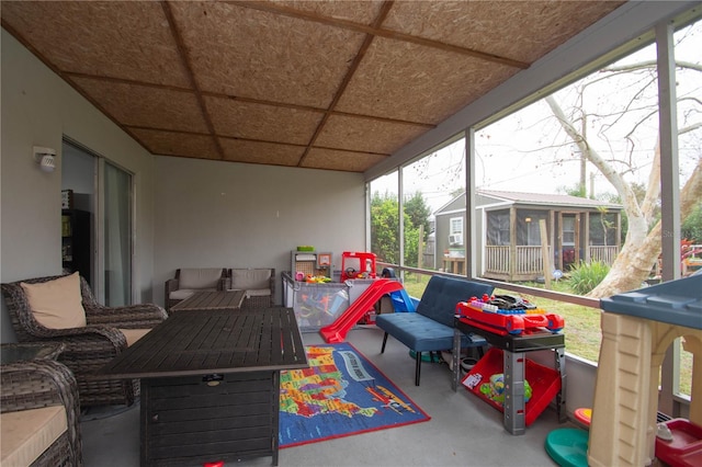 sunroom / solarium featuring a drop ceiling