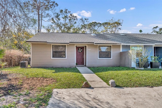 single story home with central AC and a front lawn