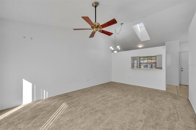 unfurnished living room with lofted ceiling with skylight, carpet, and ceiling fan