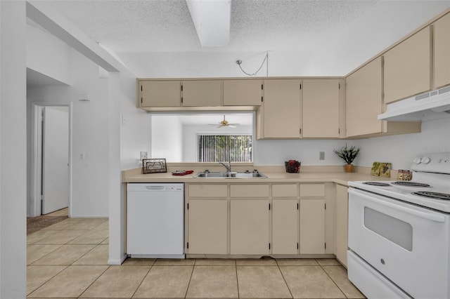 kitchen featuring light tile patterned flooring, sink, white appliances, and cream cabinetry