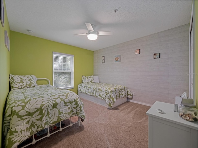 carpeted bedroom with baseboards, a ceiling fan, and a textured ceiling
