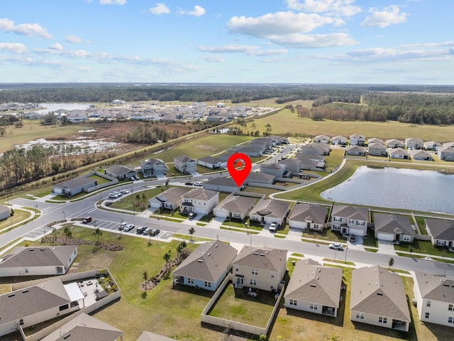 birds eye view of property with a water view