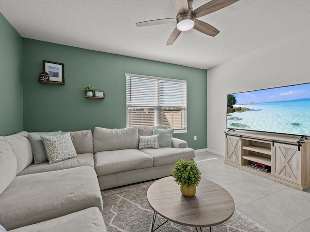 tiled living room with ceiling fan and a textured ceiling