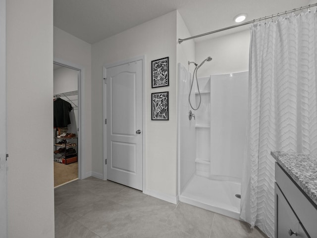 bathroom with vanity, tile patterned floors, and walk in shower