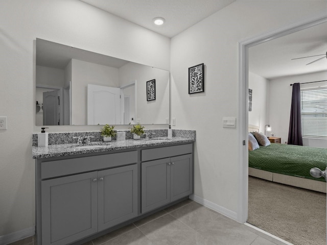 bathroom with tile patterned flooring, vanity, and ceiling fan