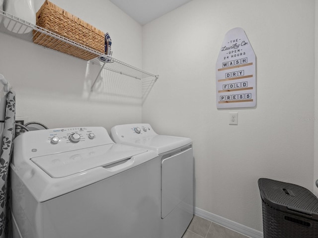 laundry room featuring washer and dryer and light tile patterned flooring