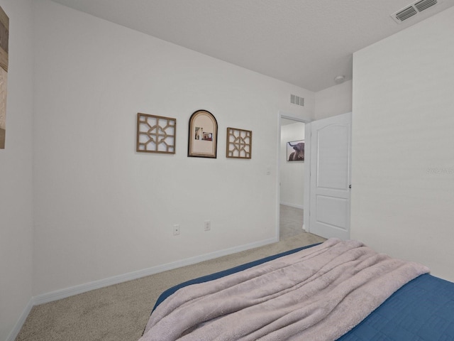 bedroom featuring light colored carpet