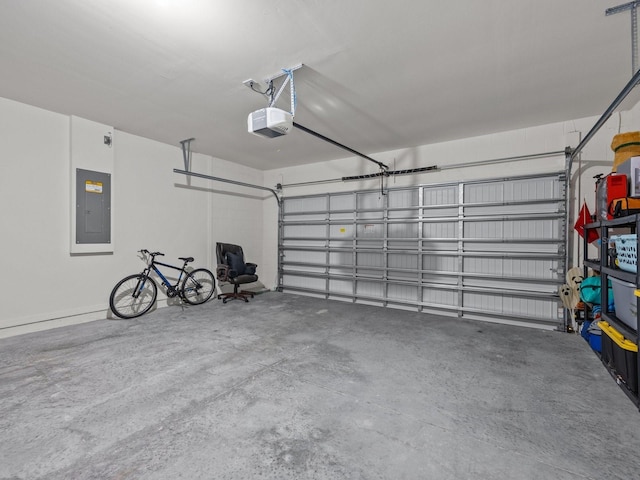 garage with a garage door opener and electric panel