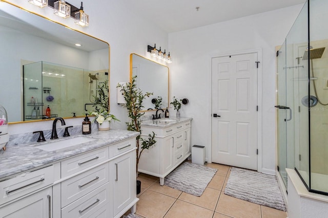 bathroom with tile patterned flooring, vanity, and walk in shower